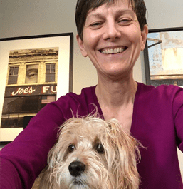Dana Perry working remotely with pup, Lucy
