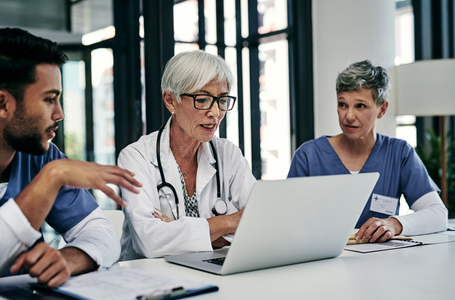 three health care professionals having a meeting