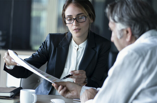 female and male business professionals reviewing documents